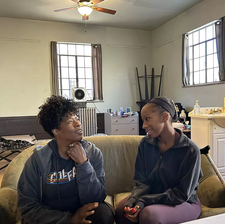 two women talking on a couch