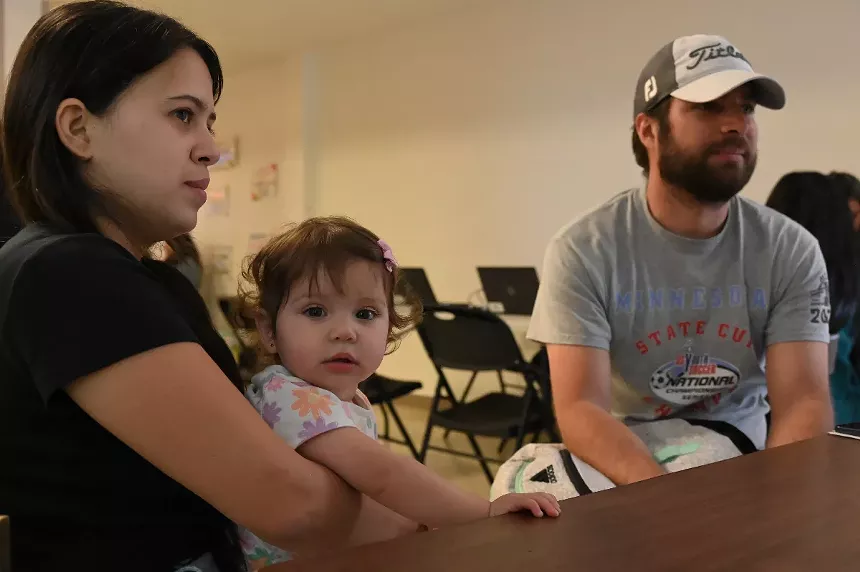 A couple holds a baby.