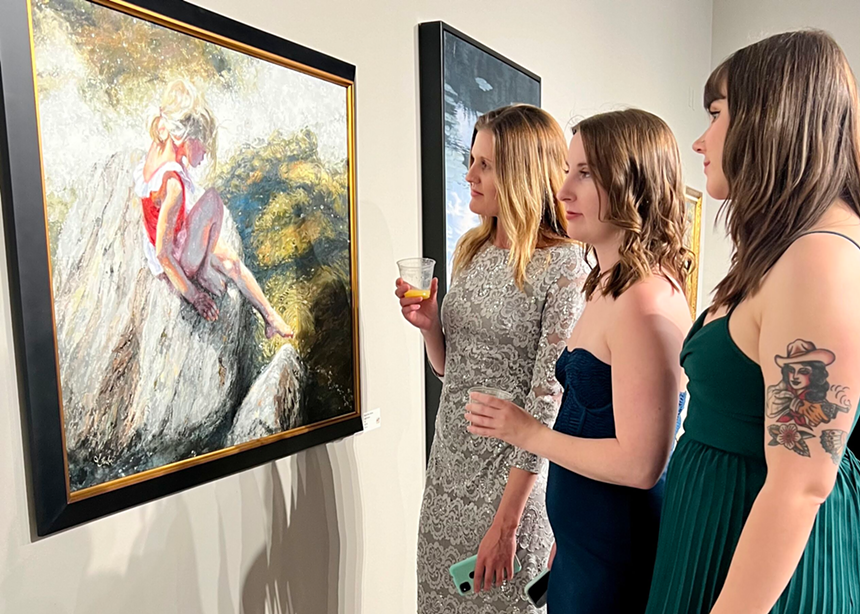 people  looking at paintings