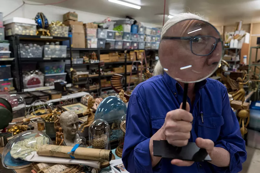 man looking through magnifying glass