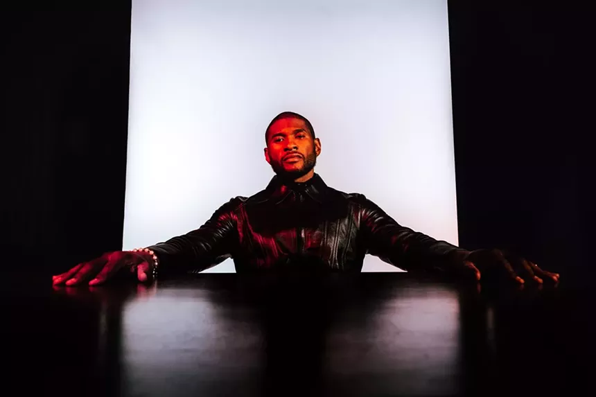 usher, in leather with arms out