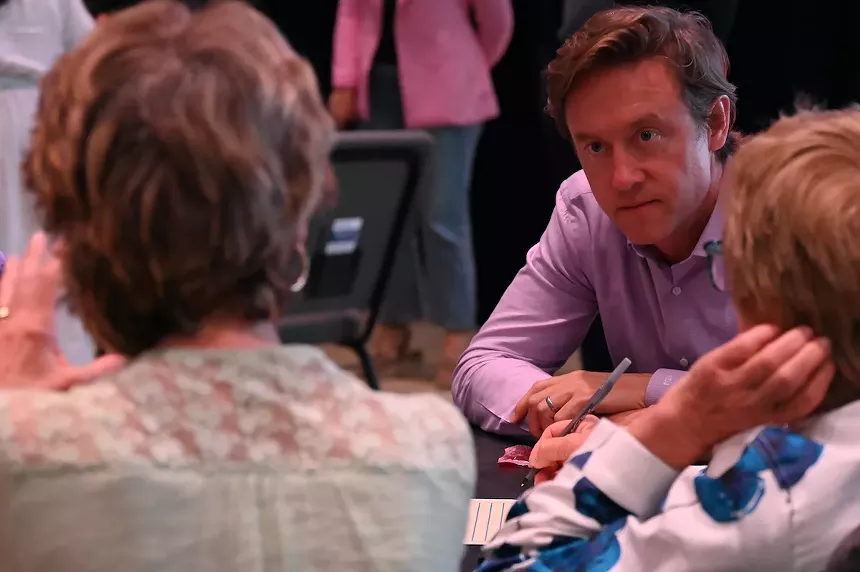 A woman talks to a man.