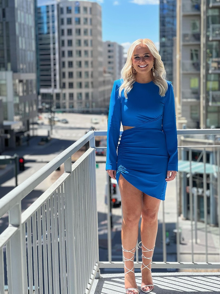 blonde woman in blue dress in city scene