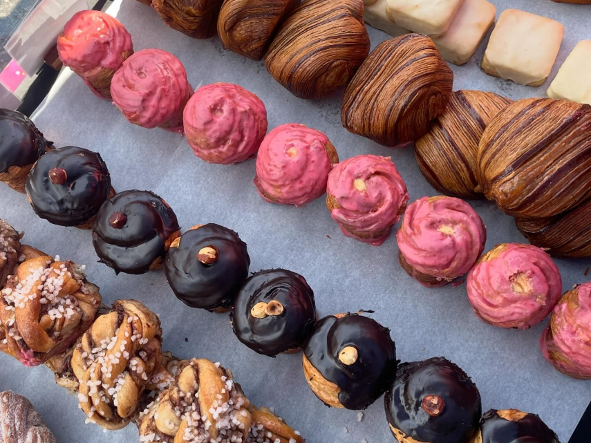 a variety of pastries lined up.