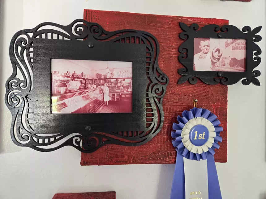 two framed old photos and a blue ribbon