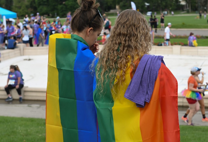 two people in Pride flag