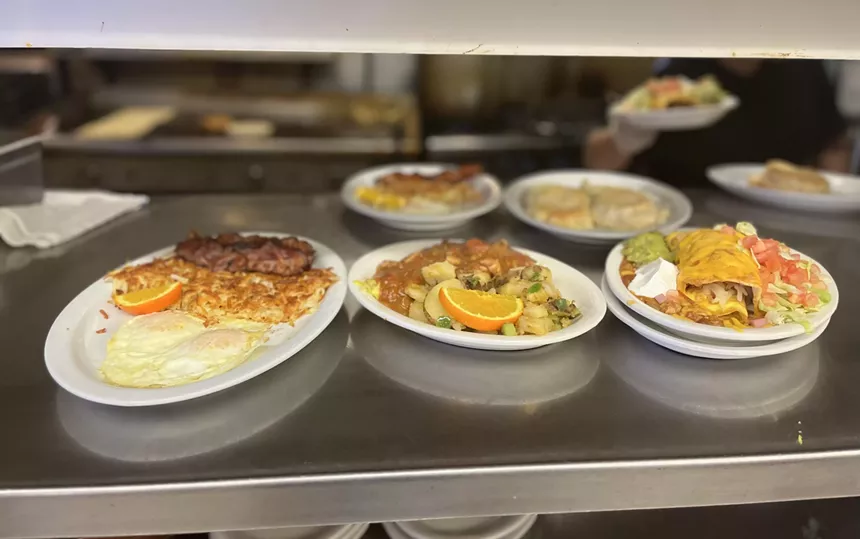 various breakfast dishes in a kitchen pass