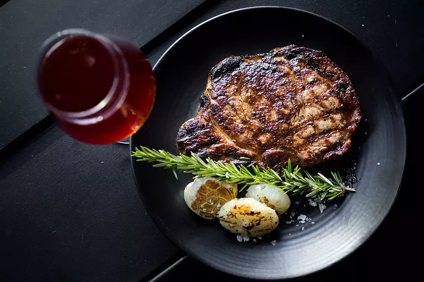 a steak and a glass of wine