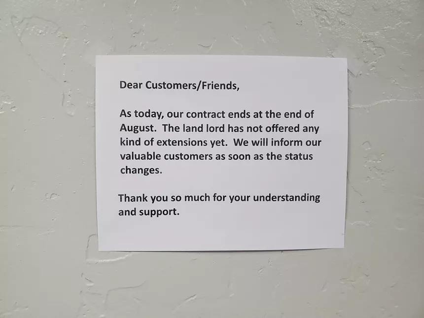 black text on a white piece of paper hanging on a wall