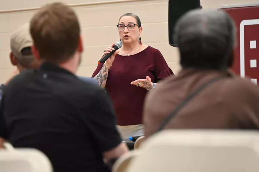 A woman talks to a crowd.