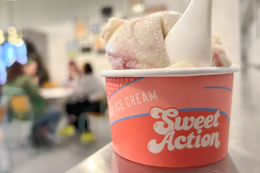 A pink Sweet Action cup filled with a scoop of vegan ice cream