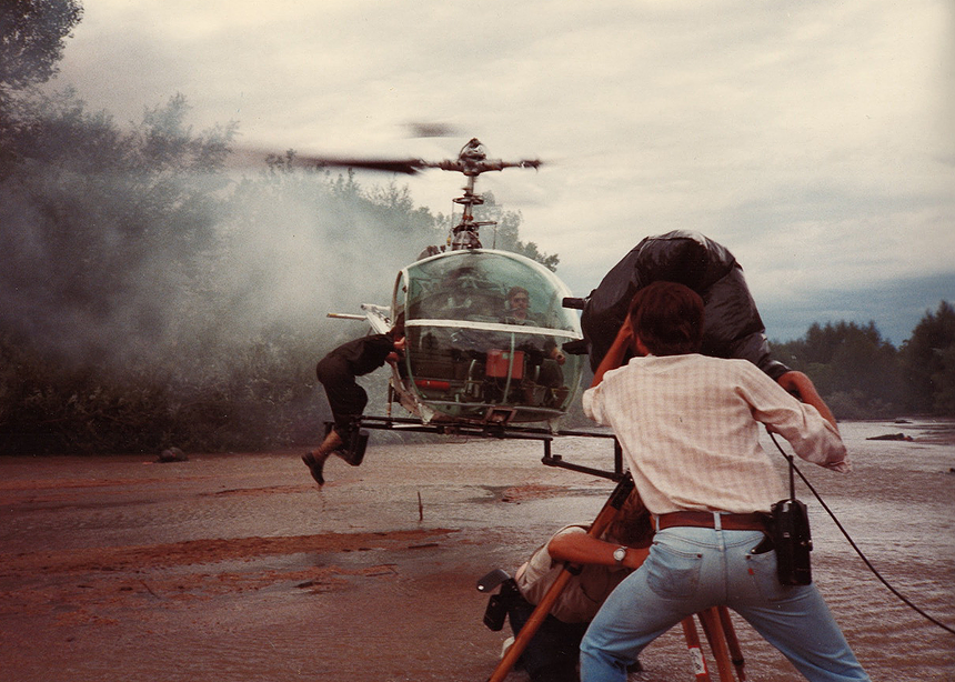 people watching a helicopter land