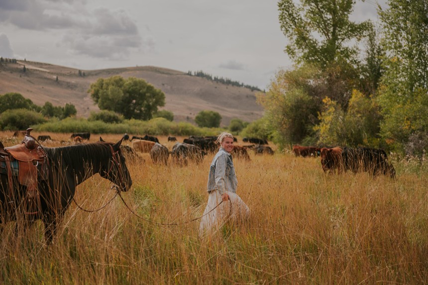 woman in a with a horse and cows