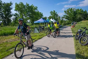 bicycle riders along trail with tent.