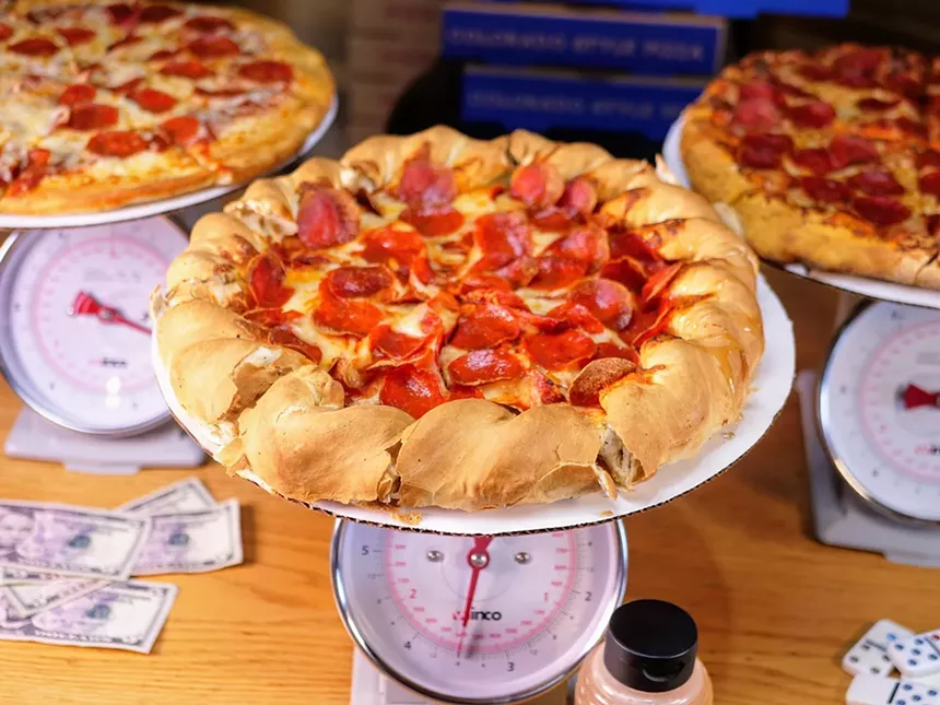 a pepperoni pizza on a scale