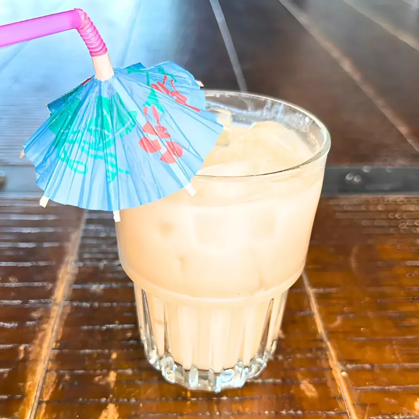 Coconut cocktail with umbrella.