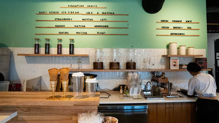 counter inside a cafe with a teal wall