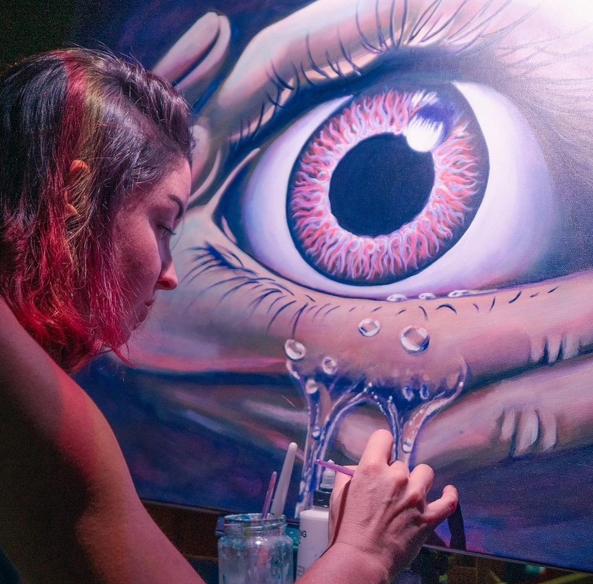 woman painting an eye