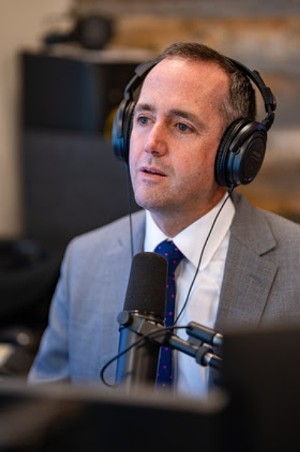 man in tie with headphones on radio