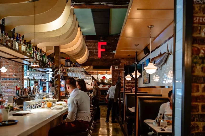 couple sitting at a bar inside a restaurant