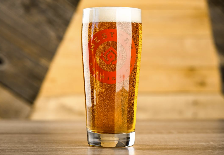 Beer in lighting in a glass with foam.