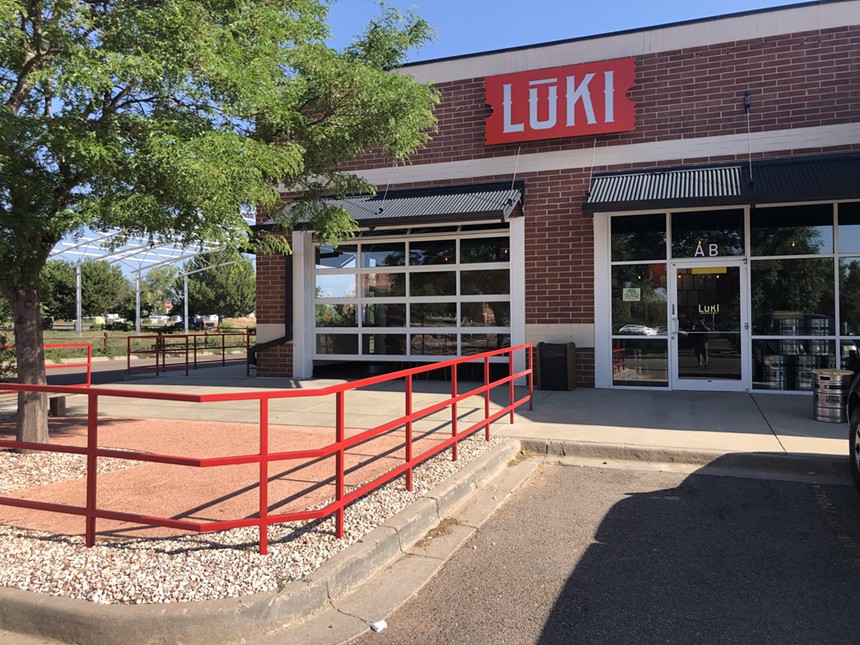 exterior of a brick building with a red sign that says "luki"