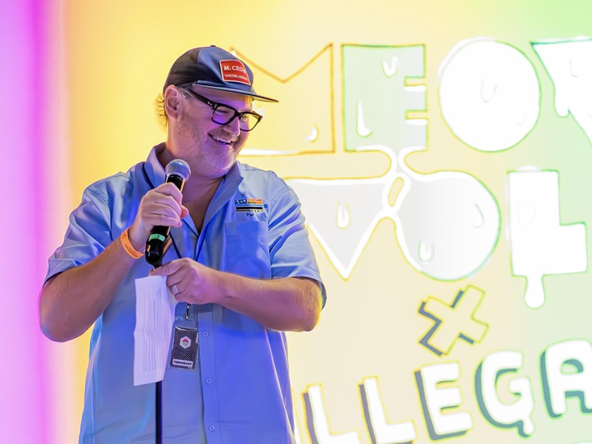 Pete Turner backdropped by a "Meow Wolf x Illegal Pete's" banner