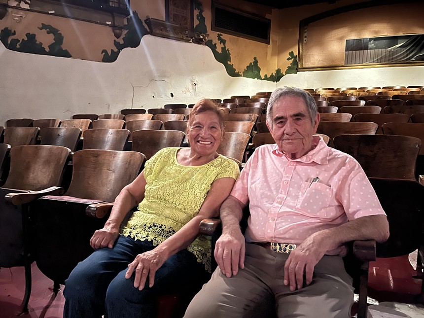 two people sitting in a theater