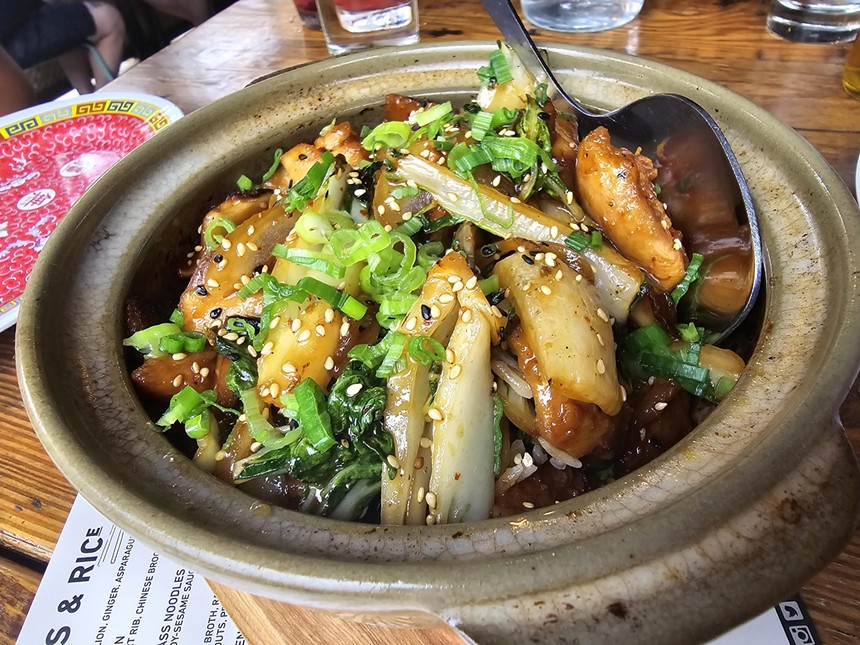 a bowl filled with chicken and vegetables