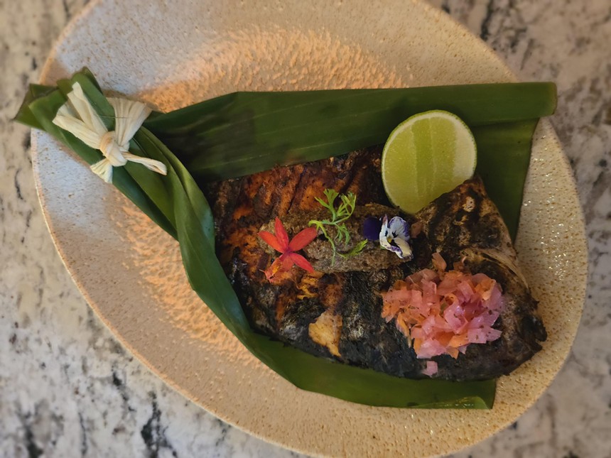 whole fish in a banana leaf