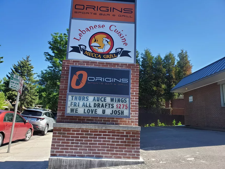A sign for businesses in a strip mall