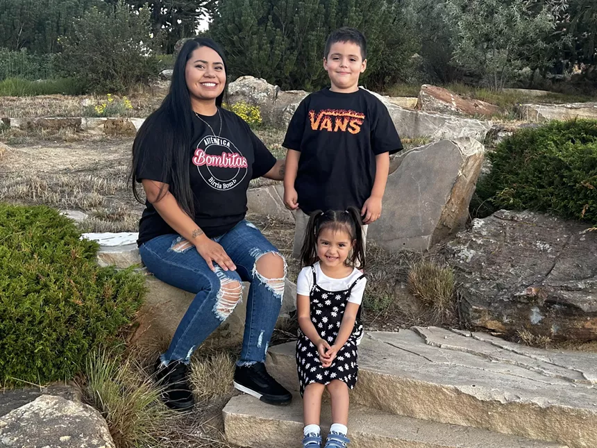 Bombitas founder Antonette Camacho posed outdoors with her two children