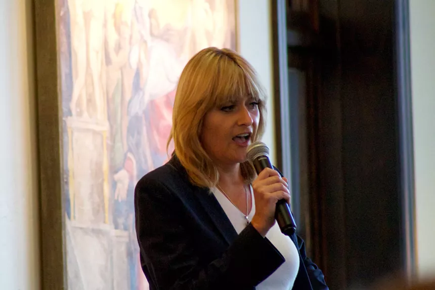 Woman holds microphone