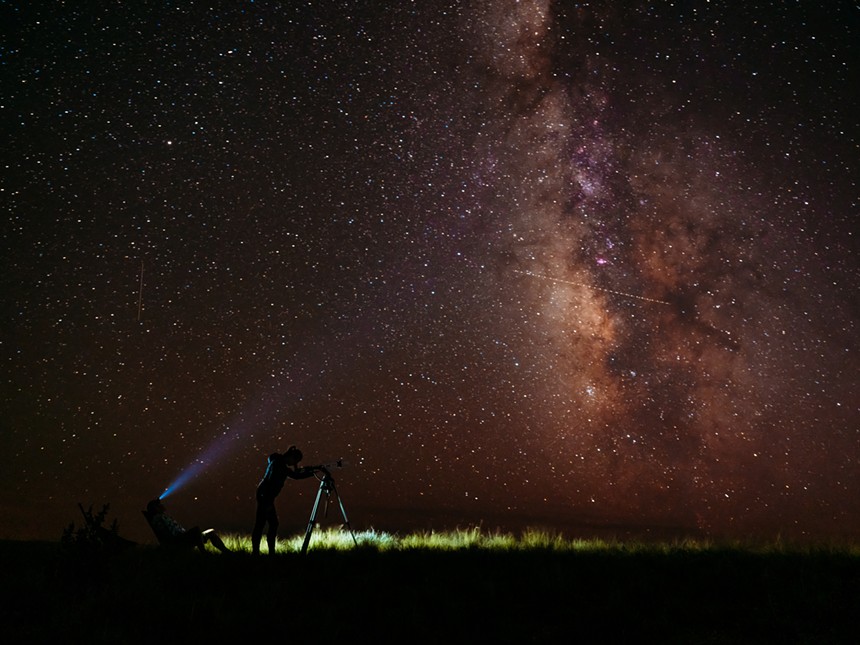 Two people looking at the starry night sky in the Comanche National Grassland