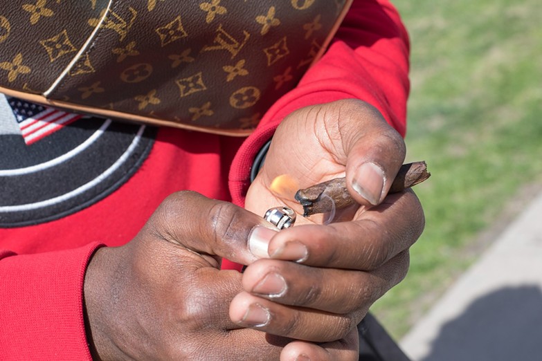 Man lights marijuana blunt