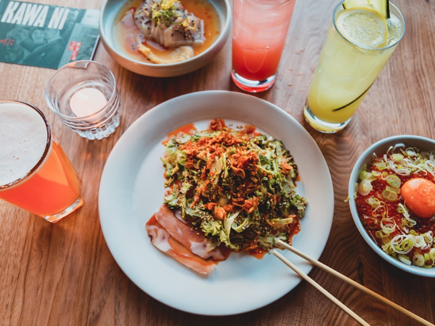 vegetables on top of thin-shaved ham on a plate surrounded by various drinks