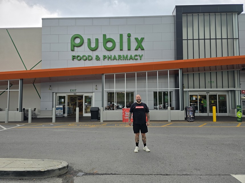 man standing in front of a publix super market