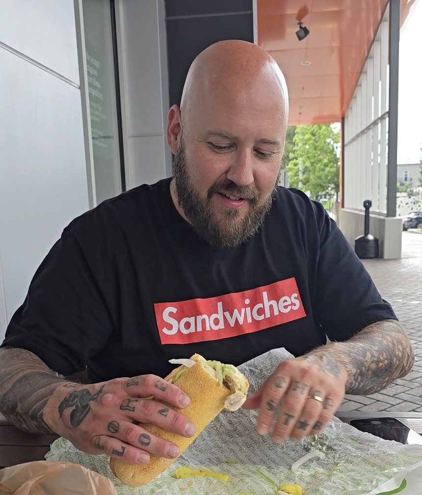 man holding a sub sandwich