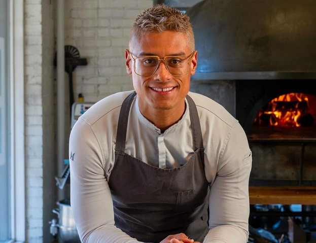 a man in glasses wearing an apron