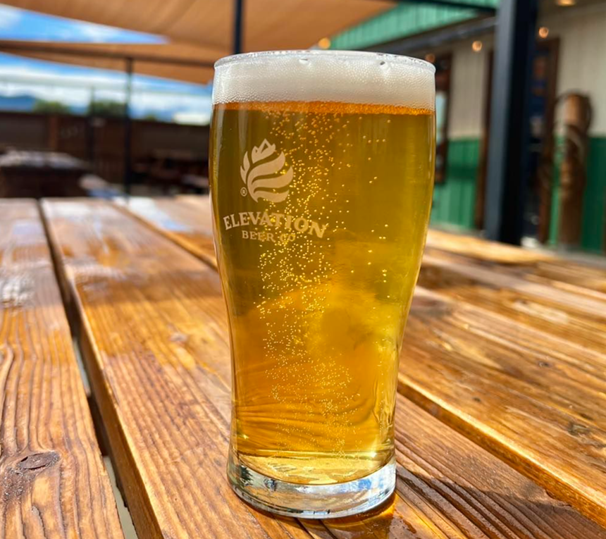 Pale beer in glass on table.