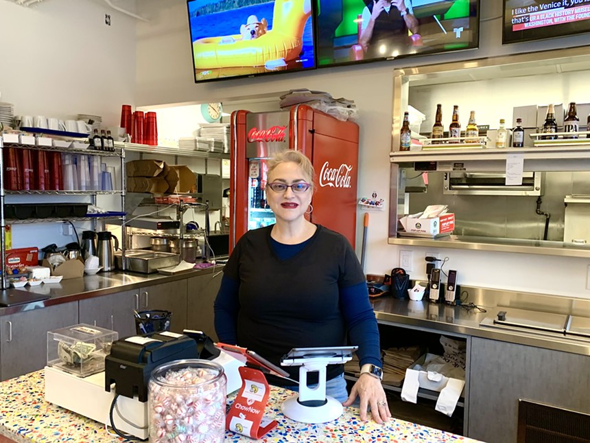 woman standing inside a restaurant