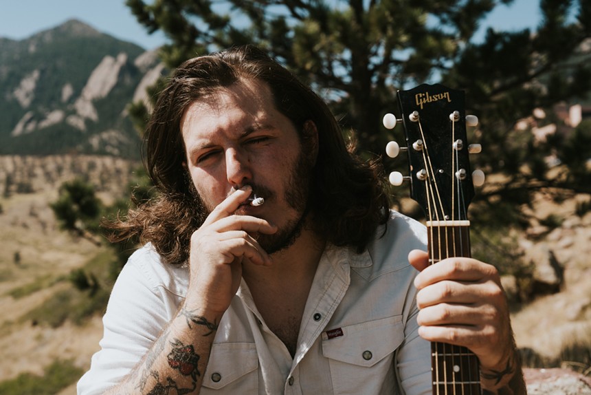 Danno Simpson smoking a cigarette in the foothills of Boulder.