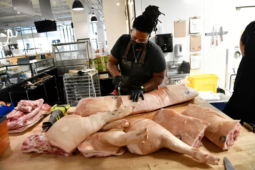 a chef breaking down pigs