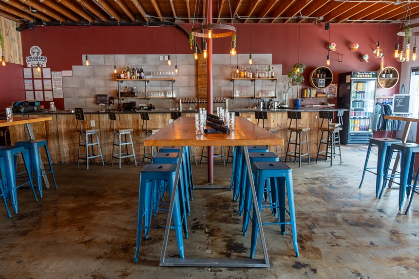 blue bar stools lined up at a table