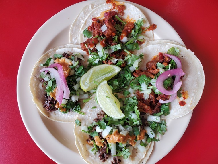 four tacos on a plate