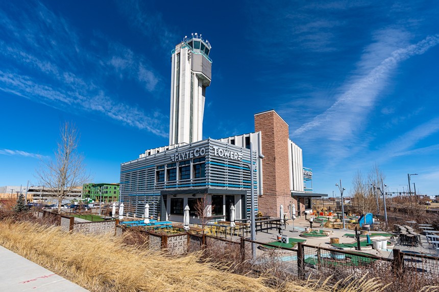 The multi-story exterior of FlyteCo Tower, featuring a former air traffic control tower and an outdoor mini golf course