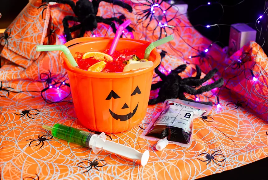 Halloween decor and a cocktail in a pumpkin tub