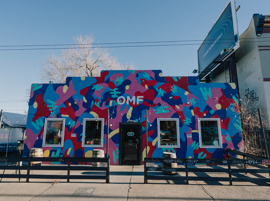 front of building covered in colorful mural