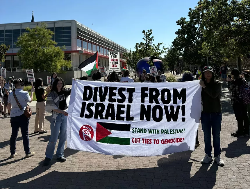 student hold pro-Palestine banner during college protest