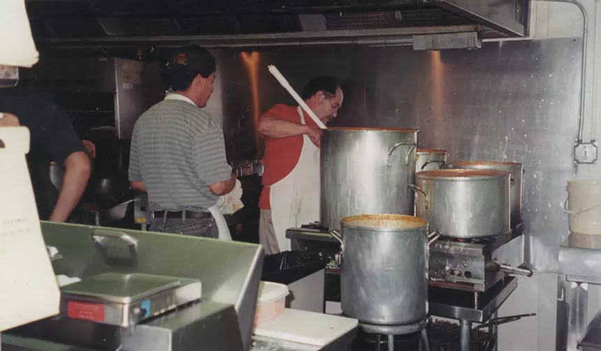 two men in a restaurant kitchen